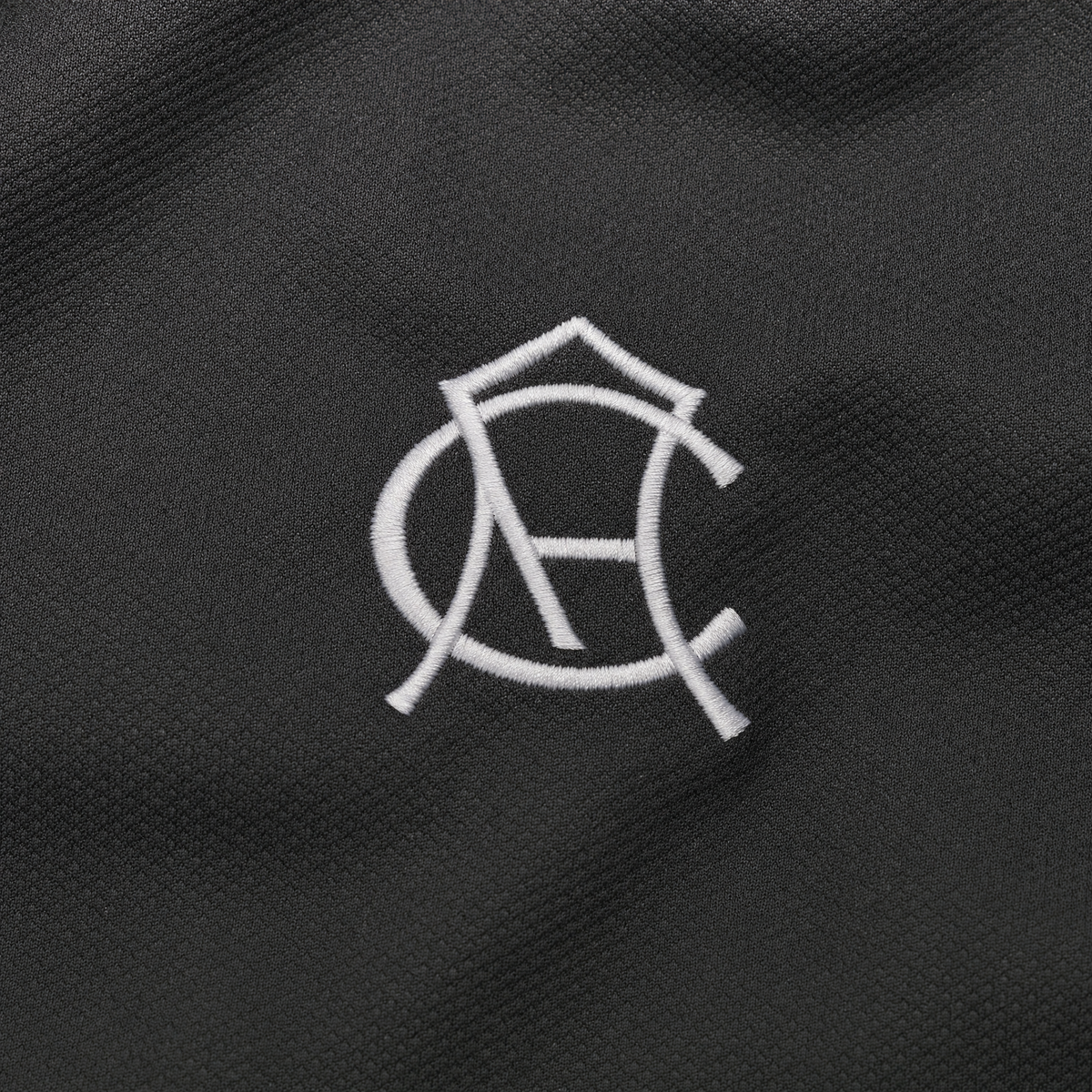 Club America 2026/27 women away jersey - historic crest and charcoal fabric macro detail