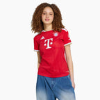 Woman wearing the Bayern Munich 2026/27 home shirt — base shirt front